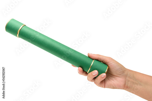 Mão feminina segurando um canudo de formatura na  cor verde, simbolizando a diplomação em um curso. Porta diplomas.   photo