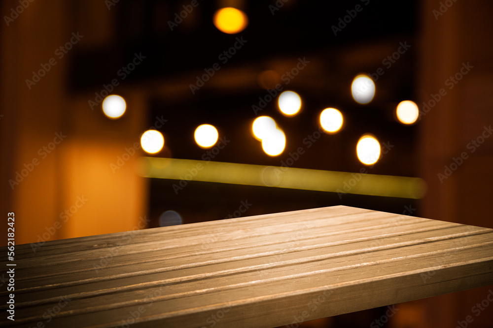 Empty workplace, table on the background of blurred cafe lights Empty workplace, table on the background of blurred cafe lights