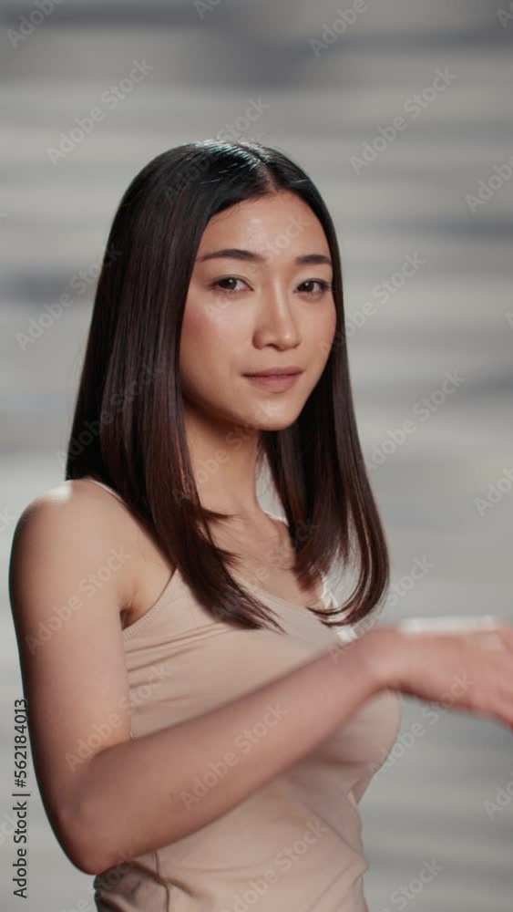 Vertical video: Gentle flawless model feeling confident on camera to promote self love and skincare routine with natural products. Young woman with glowing skin enjoying beauty campaign in studio. Vertical video: Gentle flawless model feeling confident on camera to promote self love and skincare routine with natural products. Young woman with glowing skin enjoying beauty campaign in studio.