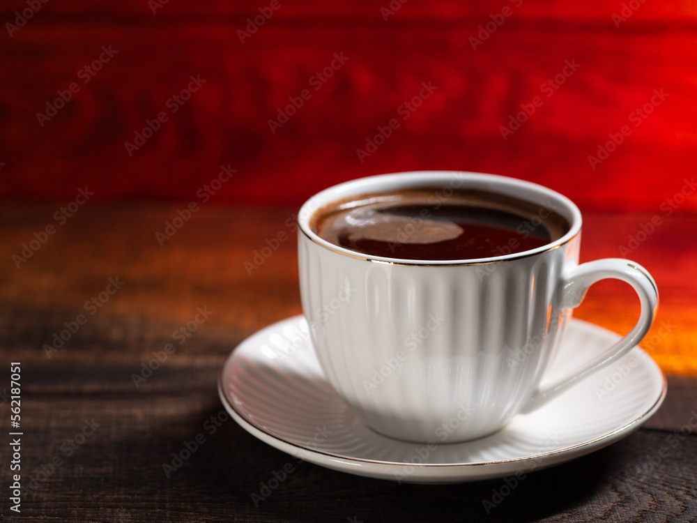 Fototapeta premium white cup of hot coffee on a wooden table copy space