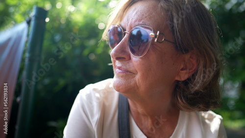 older woman wearing big sunglasses outside