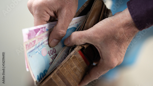 Hands holding and counting Turkish money photo