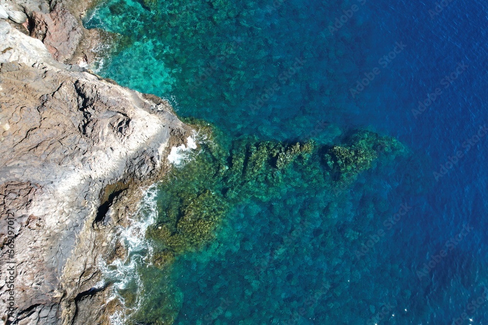 Fototapeta premium Blue ocean with clear underwater seascape near the volcanic coast of El Hierro, Canary Islands, Spain. Top view aerial shot.