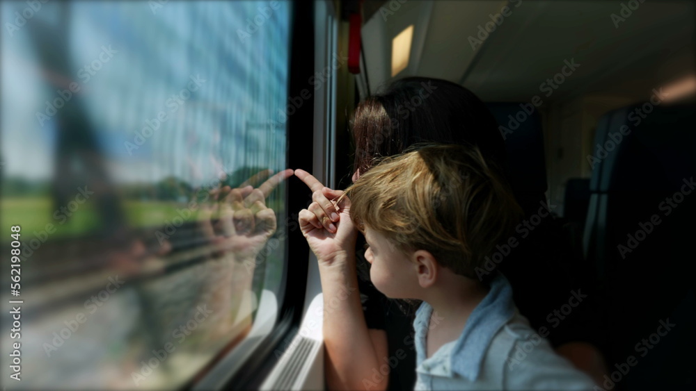Mother and baby child traveling together by train. parent mom pointing finger to landscape Mother and baby child traveling together by train. parent mom pointing finger to landscape