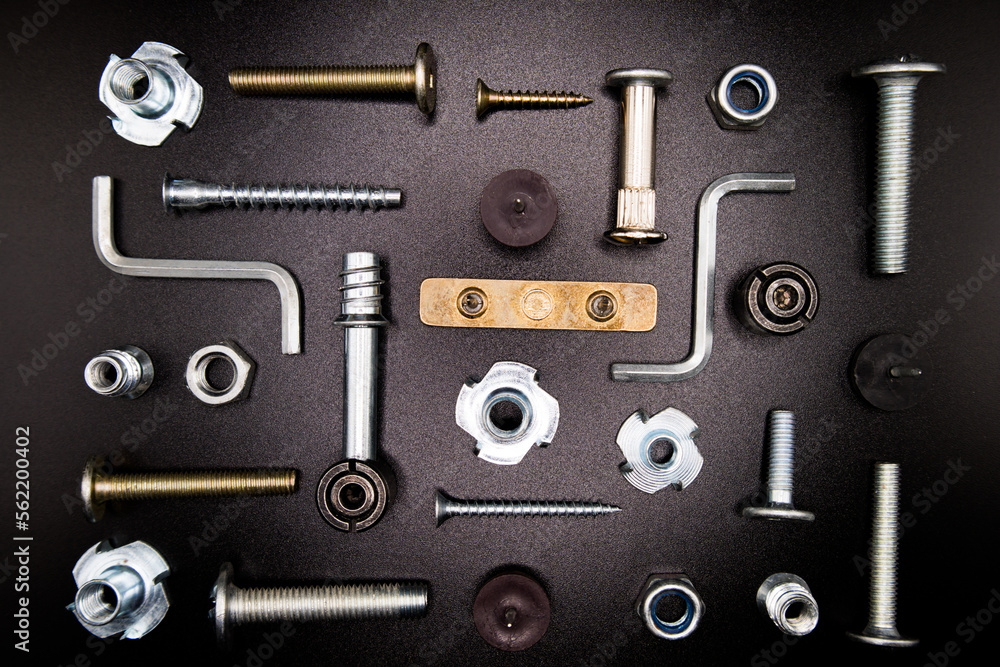Furniture fittings. Furniture assembly hardware options and tools on a black background. Large selection of furniture accessories. Furniture fittings. Furniture assembly hardware options and tools on a black background. Large selection of furniture accessories.