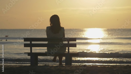 Romantic woman sit on bench at seaside, beauty sunrise, seascape