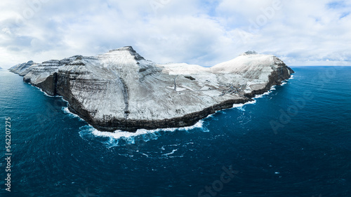most amazing view on the faroe islands with snow mountains and turquoise ocean water