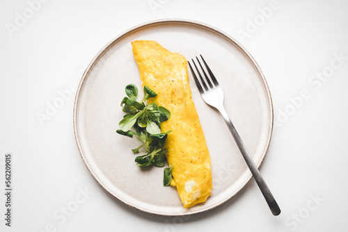 Photos French omelette with salad. Top view on healthy breakfast.