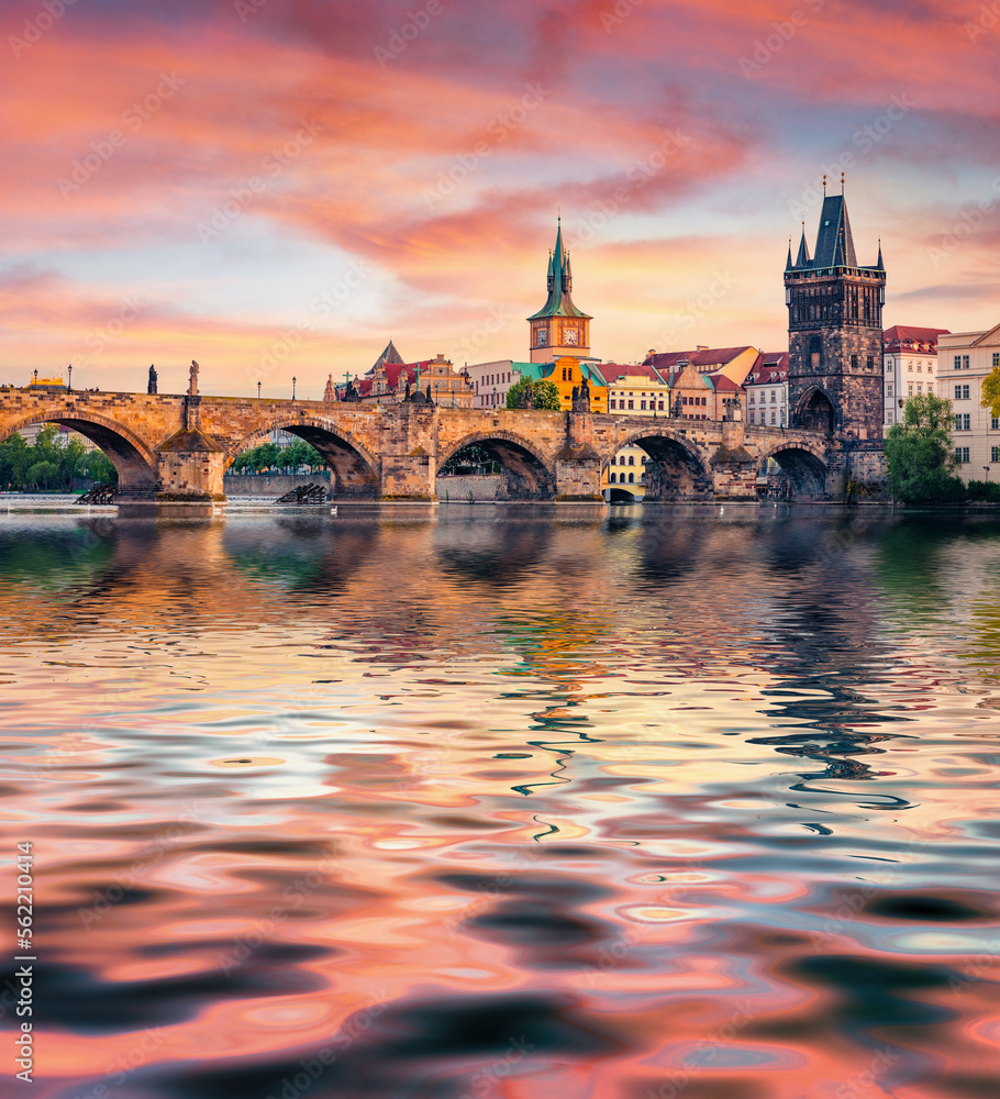 Great sunset on Vltava river. Superb summer cityscape of Prague town with Charles bridge (Karluv Most) on background, Czech Republic, Europe. Traveling concept background..