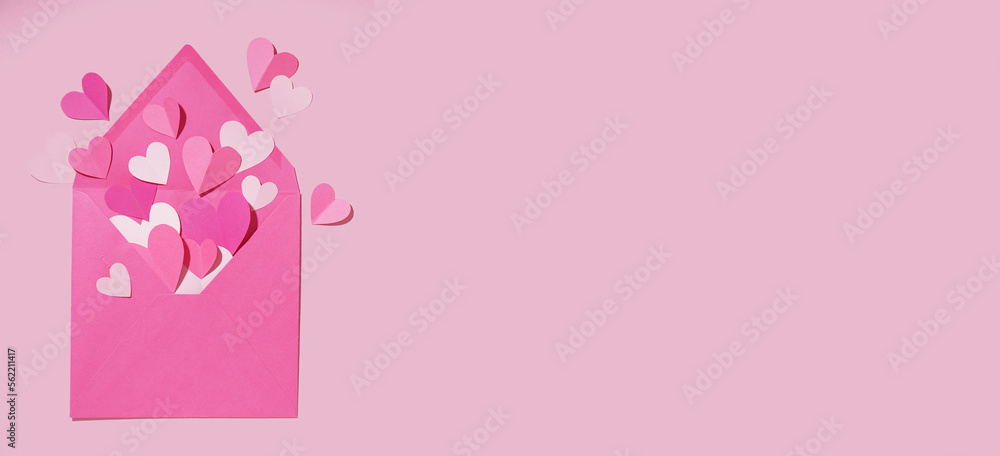 Envelope with paper hearts on pink background with space for text. Valentines Day celebration