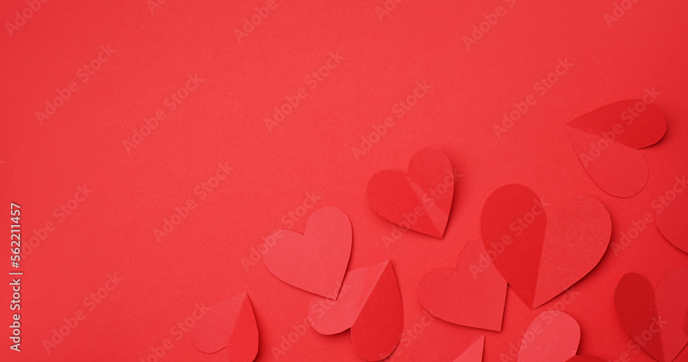 Many paper hearts on red background with space for text. Valentines Day celebration