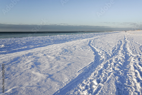 Snowy  cold winter sunny afternoon on the coast of the Baltic Sea  footprints in the snow