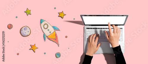 Space exploration theme with rocket and laptop