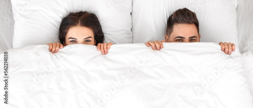Young couple lying in bed a...