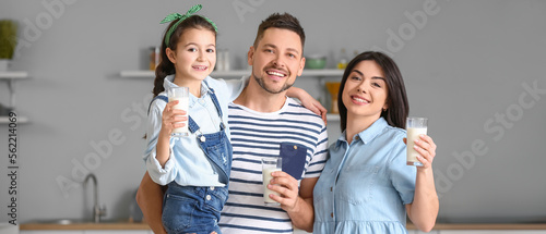 Happy family drinking milk ...
