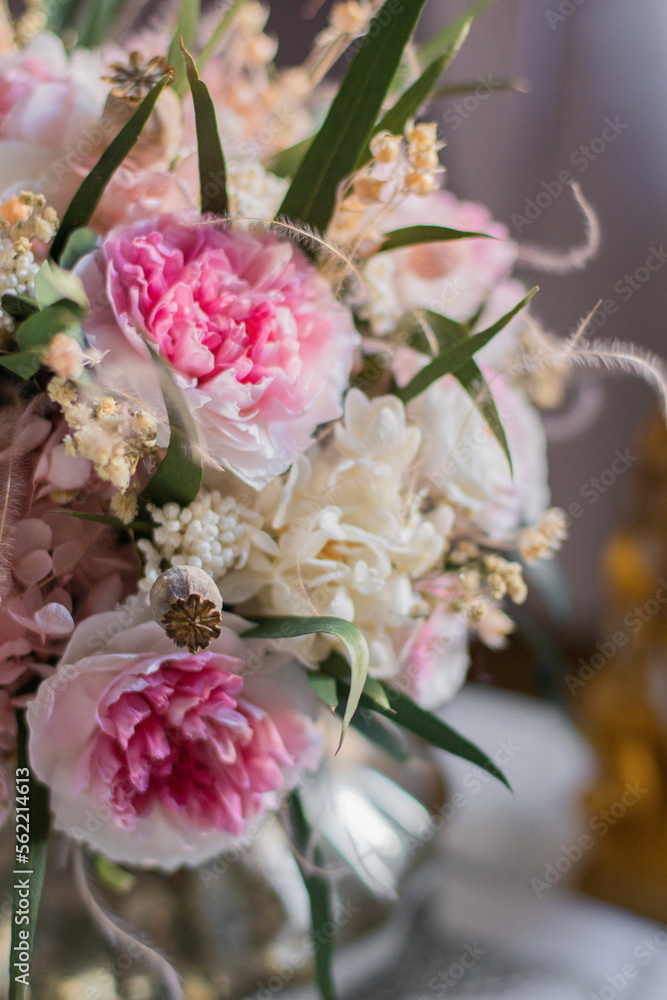 Bouquet with roses, hydrangea. Stabilized flowers in a white ceramic vase at home on the dressing table. Interior decor. Bouquet with roses, hydrangea. Stabilized flowers in a white ceramic vase at home on the dressing table. Interior decor.