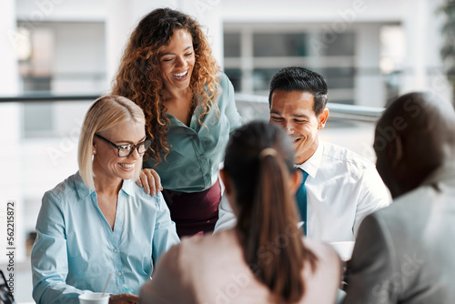 Smiling businesspeople working together around a table