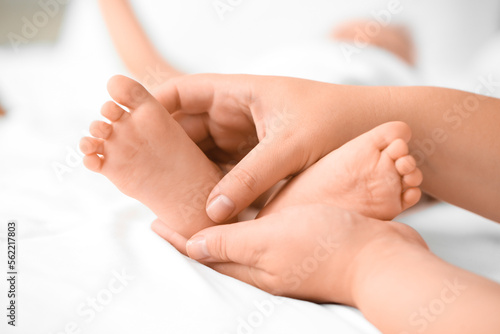 Wallpaper Mural Mother massaging her baby's feet in bedroom, closeup Torontodigital.ca