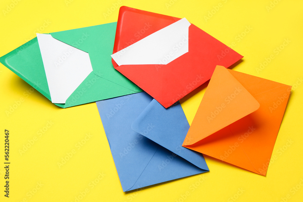 Different envelopes on yellow background, closeup Different envelopes on yellow background, closeup