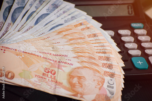 turkish banknotes and calculator on table photo