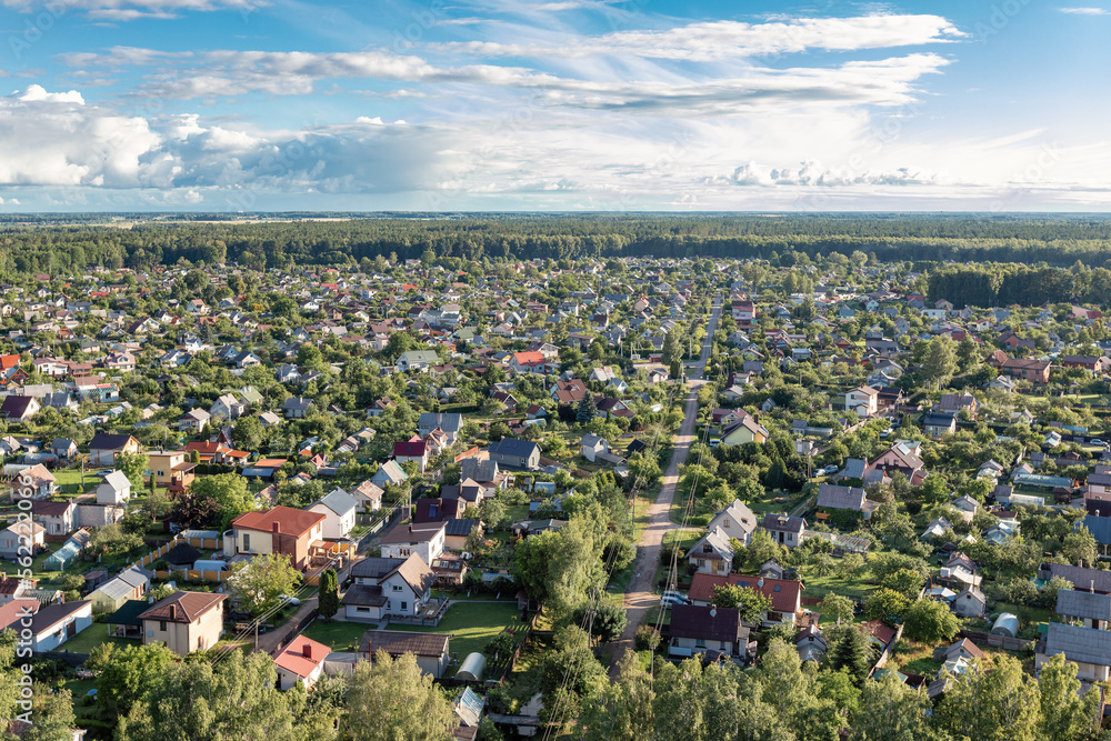 Collective gardens, a settlement in the middle of the forest photographed from a hot air balloon