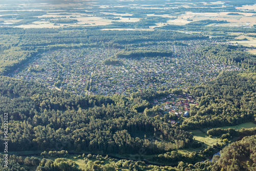 A large settlement with small houses in the middle of the forest  view from above