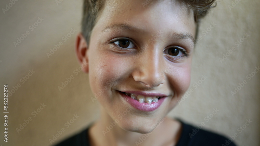 Portrait young boy child smiling at camera. Close-up kid face looking at camera Portrait young boy child smiling at camera. Close-up kid face looking at camera