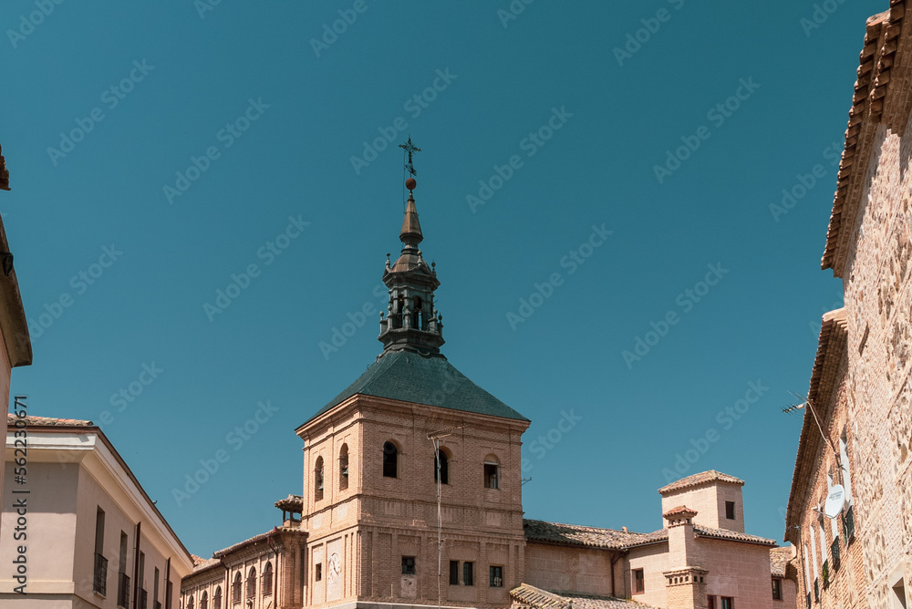 Toledo, España. April 29, 2022: Domes and facade of city churches with blue sky.
