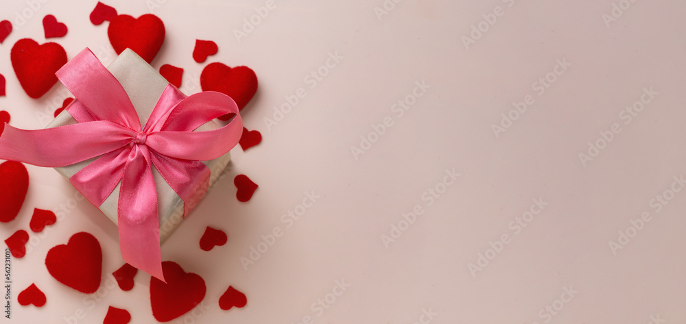 Valentine's day background. Pastel banner with red hearts and gift with ribbon. Place for text. Valentine's day background. Pastel banner with red hearts and gift with ribbon. Place for text.