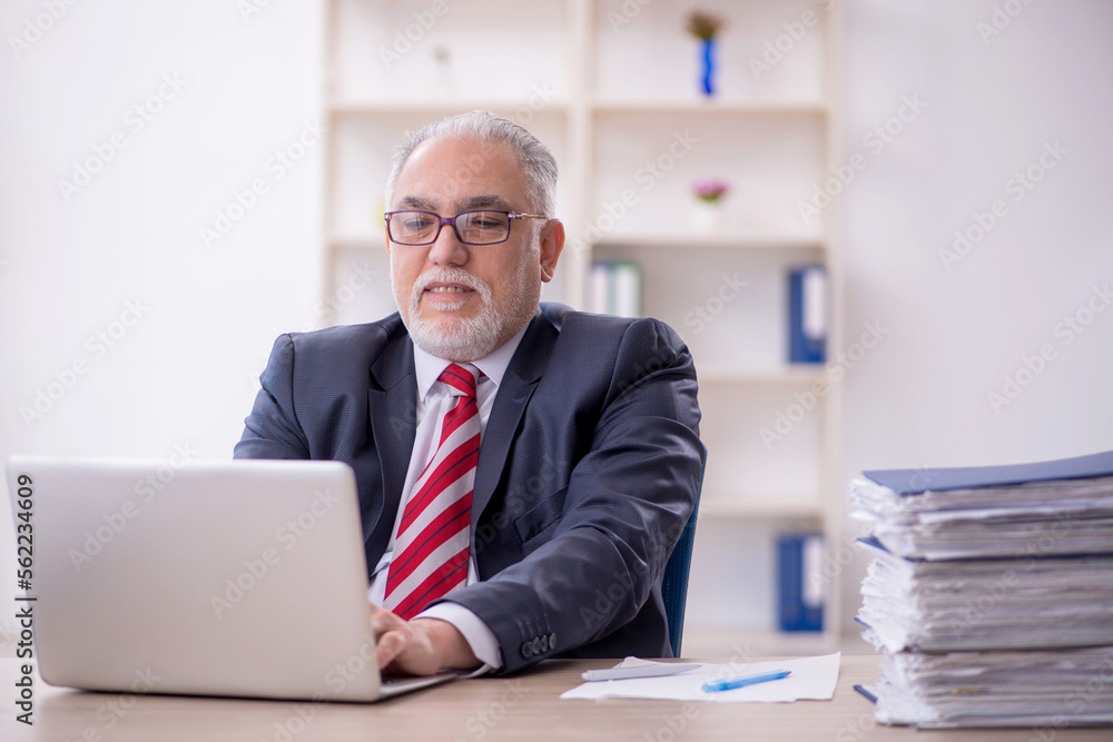 Old male employee and too much work in the office Old male employee and too much work in the office