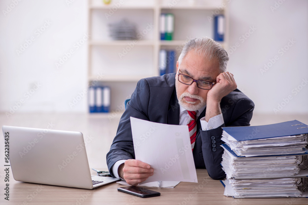 Old male employee and too much work in the office Old male employee and too much work in the office