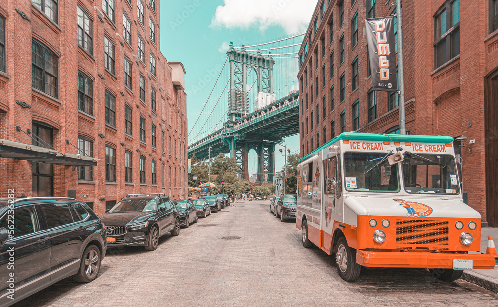 Manhattan Bridge seen from Brooklyn in narrow alley enclosed by two brick buildings on a sunny day in Washington street in Dumbo, Brooklyn, NYC - obrazy, fototapety, plakaty 