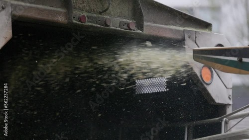 Slow motion of wood chipper blowing chips into truck bed at 240 fps HD