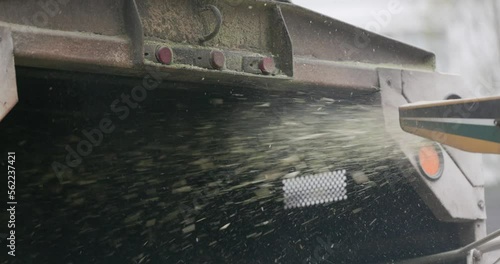 Wood chipper blowing chips into truck bed at 4k 120fps