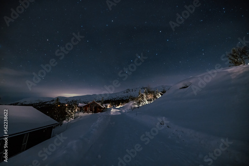 Milky Way stars under Cabin House in Norway. Christmas Night with Snow House Hytte © MelaniePhotos