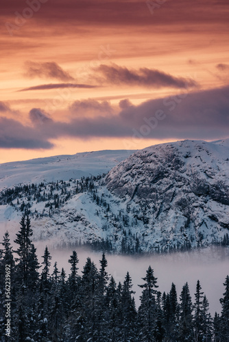 Mountain peak during sunrise . Natural landscape in the Norway at winter time.