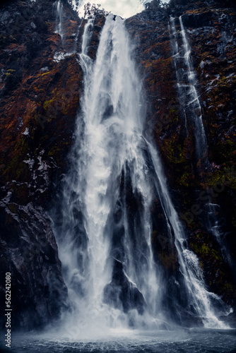 Closeup Of Mountain Waterfall Cascading Into Water at Sterling Falls, Milford Sound in Fiordland National Park, New Zealand