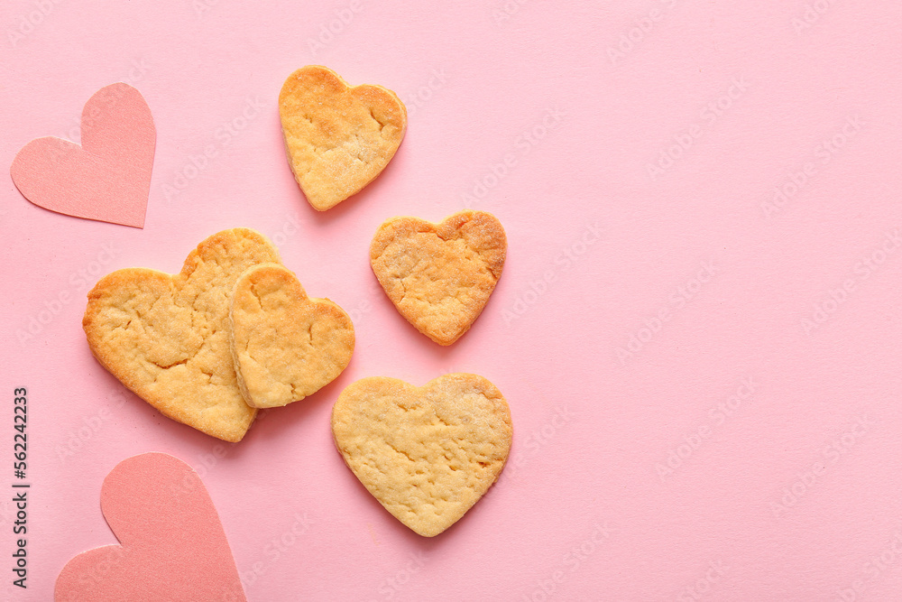 Sweet cookies and paper hearts on pink background. Valentines Day celebration