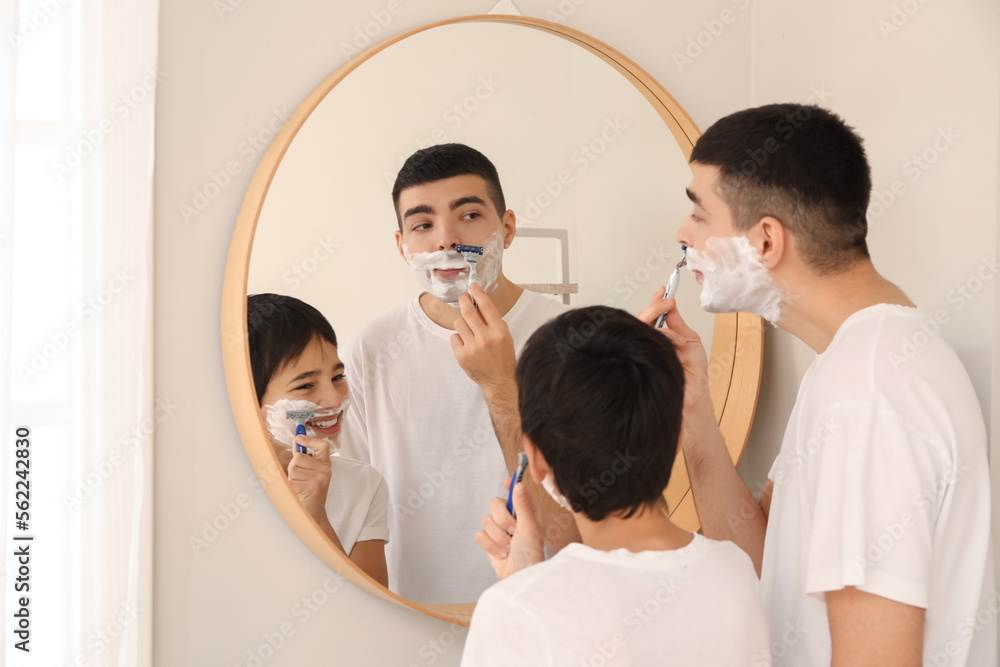 Morning of father and his little son shaving in bathroom Morning of father and his little son shaving in bathroom