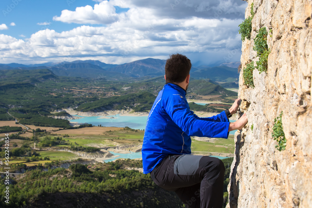 Naklejka premium Intrepid mountaineer looking at the mountains from the top