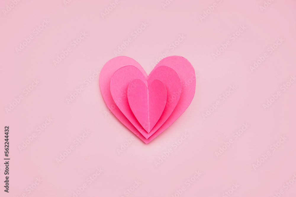 Paper heart on pink background. Valentines Day celebration
