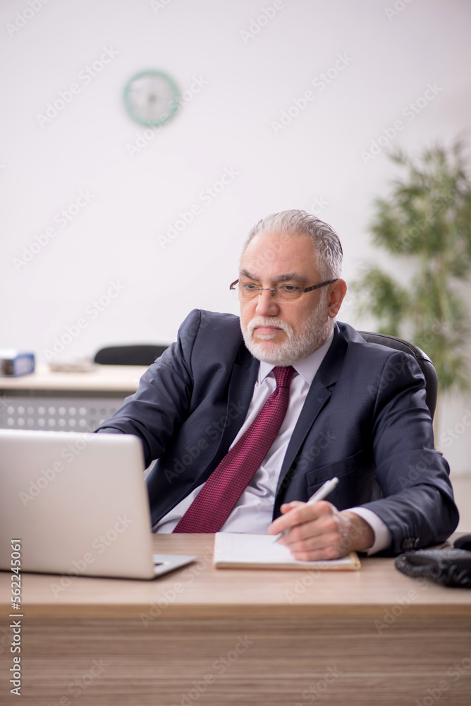Old male employee and too much work in the office Old male employee and too much work in the office