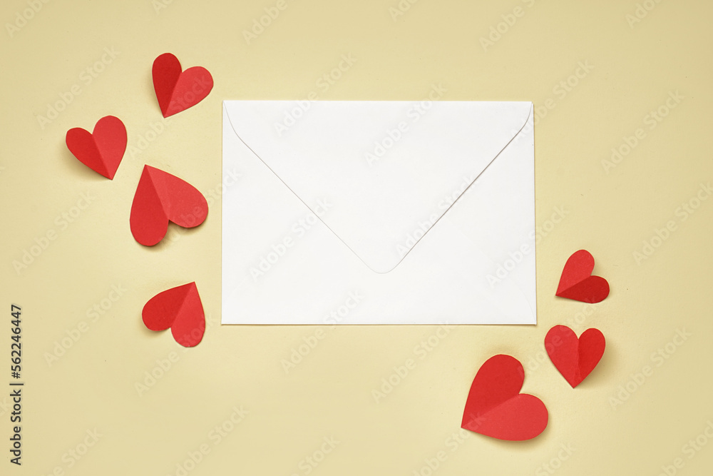 Composition with envelope and red paper hearts on color background. Valentines Day celebration Composition with envelope and red paper hearts on color background. Valentines Day celebration