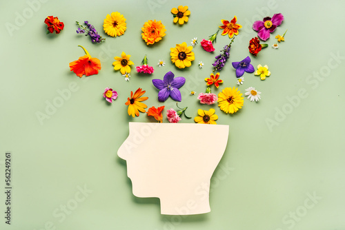 Photographie Human head symbol and flowers on blue background
