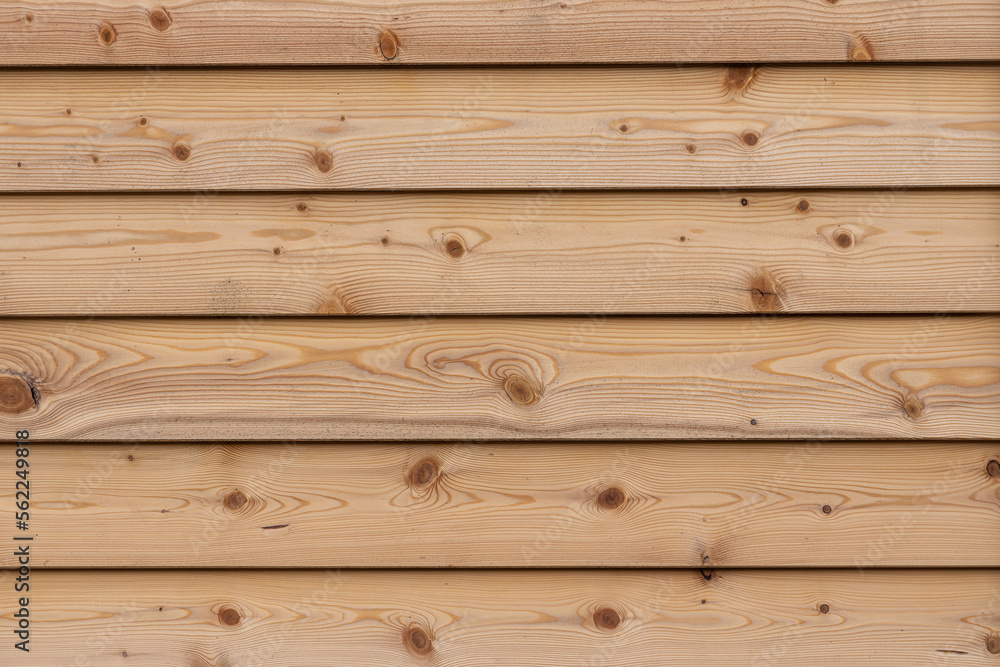 Fototapeta premium A texture of brown boards with knots and resin painted with impregnation for wood