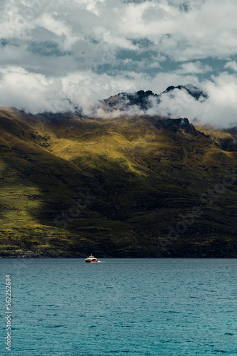 Vertical Shot of Red and White Boat on Lake in New Zealand Nature Landscape 