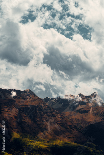Fototapeta Naklejka Na Ścianę i Meble -  Vertical Shot of Clouds and Mountains in New Zealand Landscape