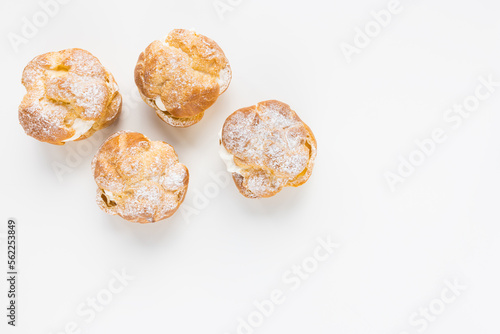 Choux Bun with whipped cream and sugar powder on top. French pastry