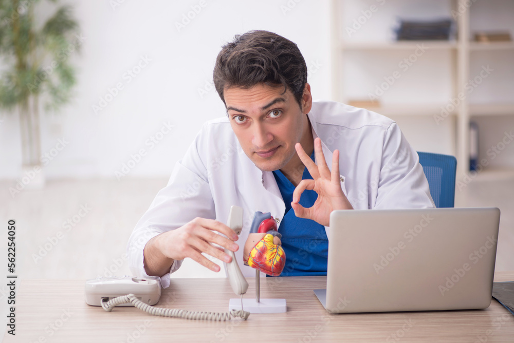 Young male doctor cardiologist working in the clinic Young male doctor cardiologist working in the clinic