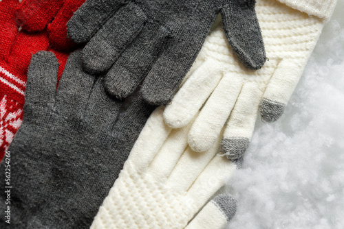 Gloves on a white background. Snowy background. Close up. COPY SPACE.